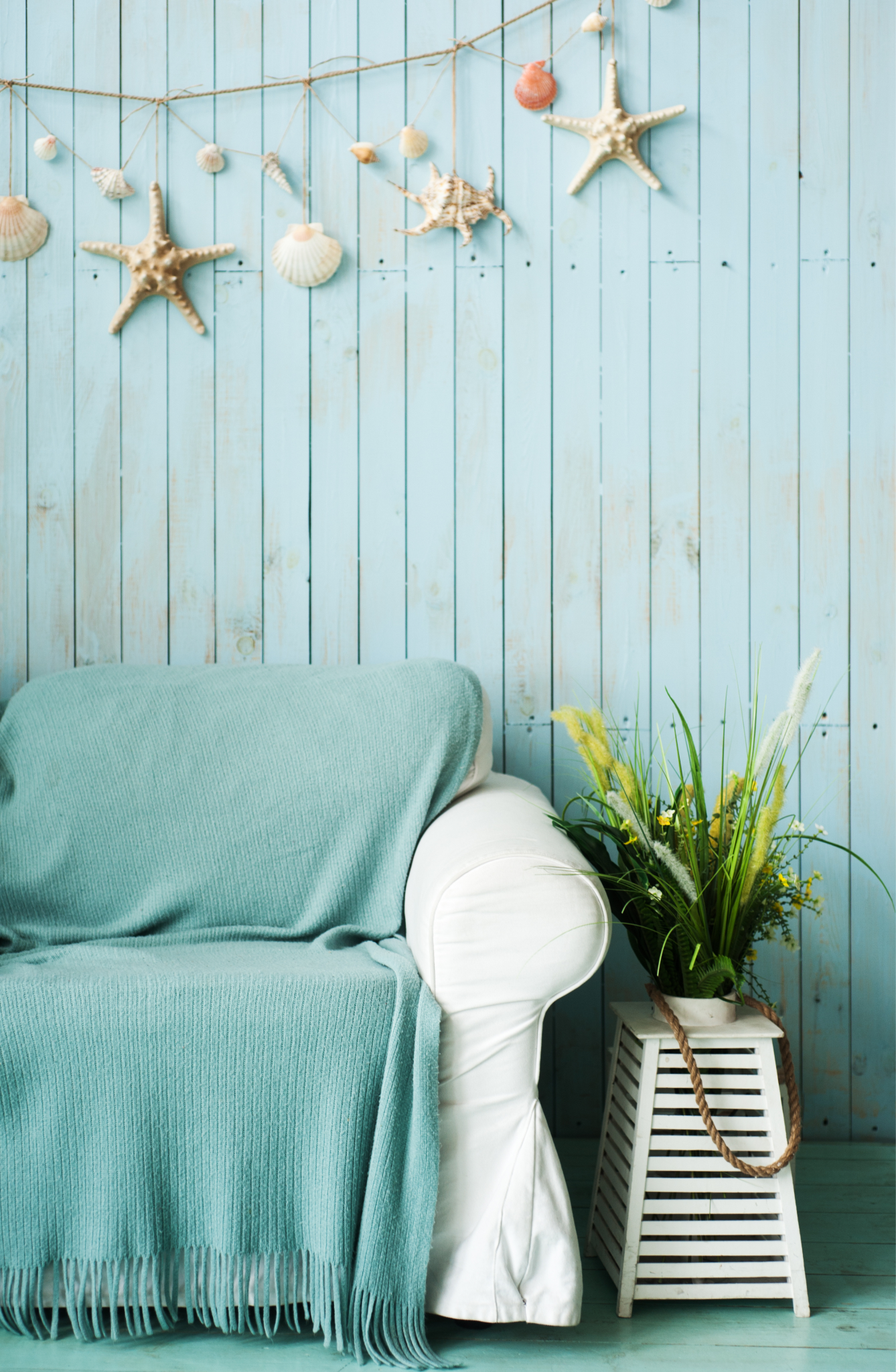 Coastal living room with blue sofa and beach wall decor